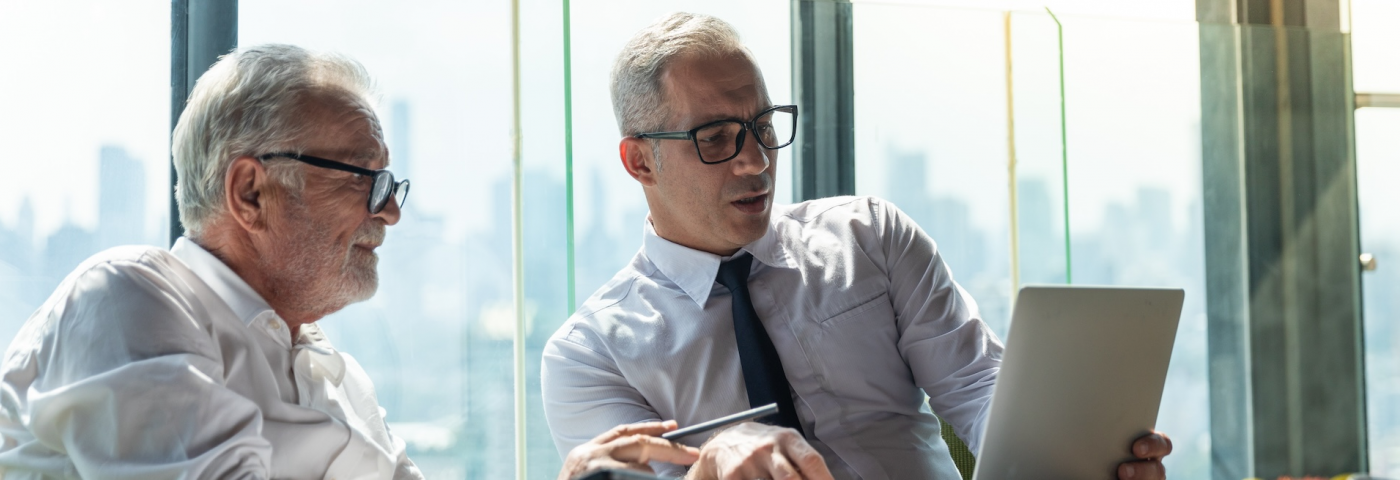 bizmeeting-2-older-white-guys-on-computer-with-skyline-shutterstock-2017450367.jpg
