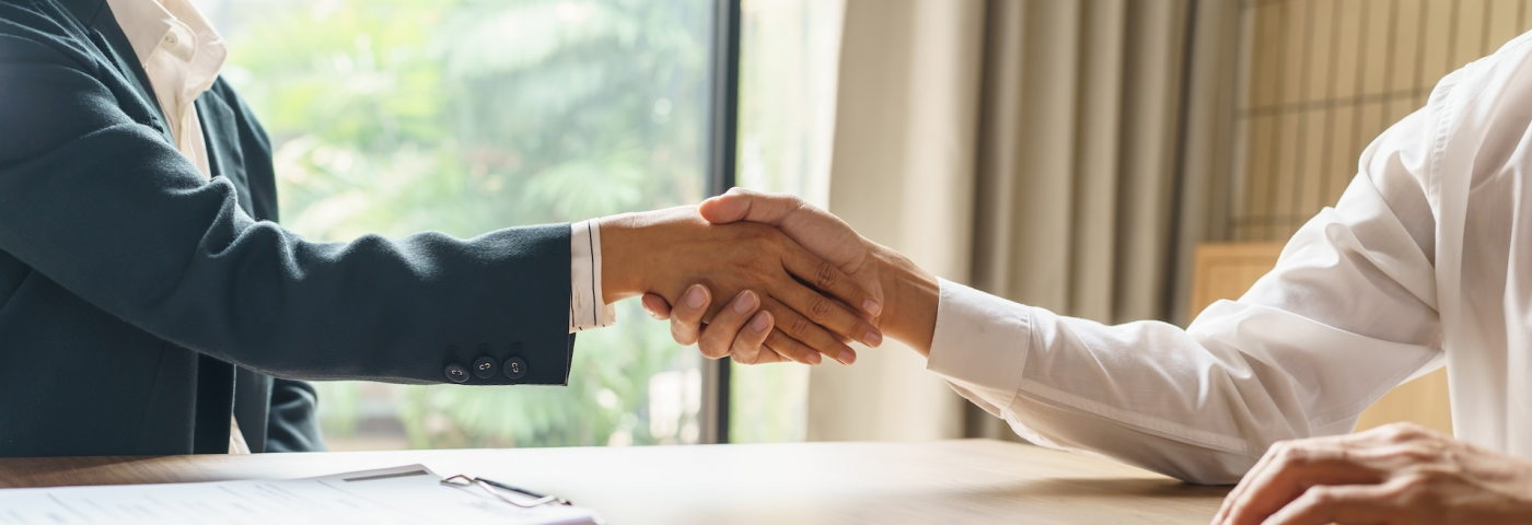bizmeeting-black-woman-white-man-shaking-hands-shutterstock-2306619159.jpg